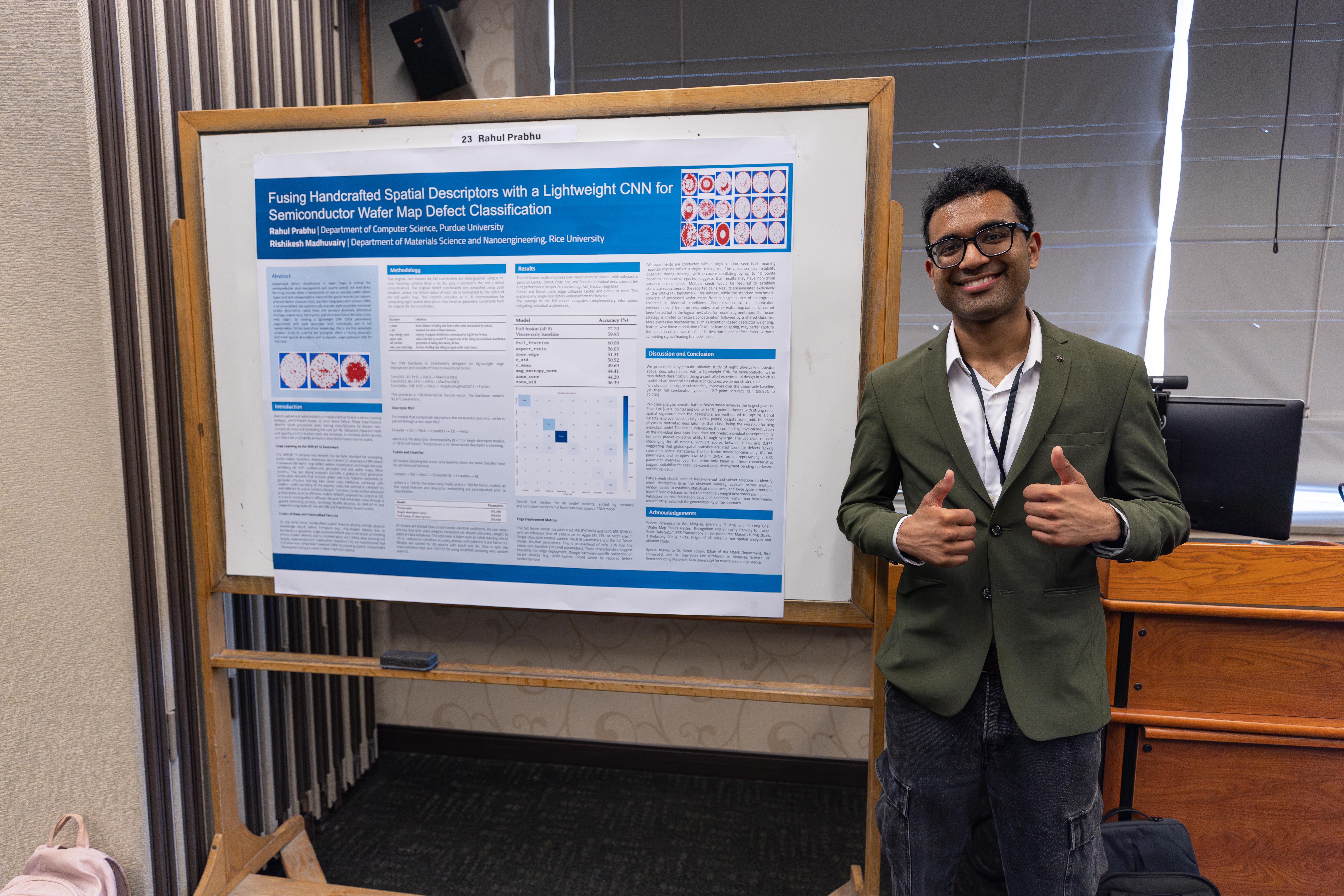 Rahul Prabhu standing next to his winning poster at the student poster session