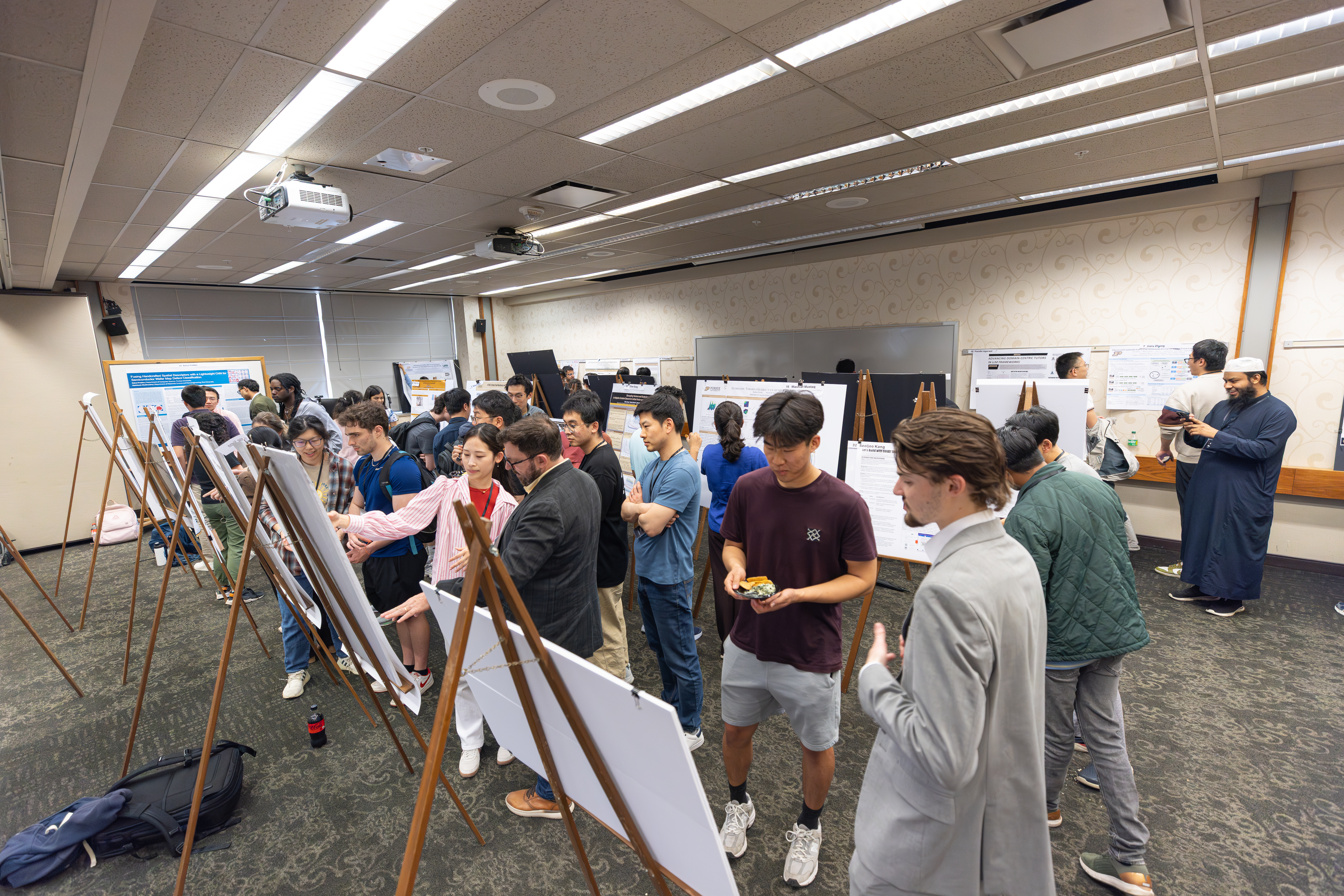 Room full of students presenting at Poster Session