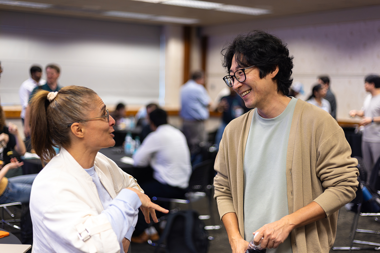 RSE Team member and attendee conversing and smiling