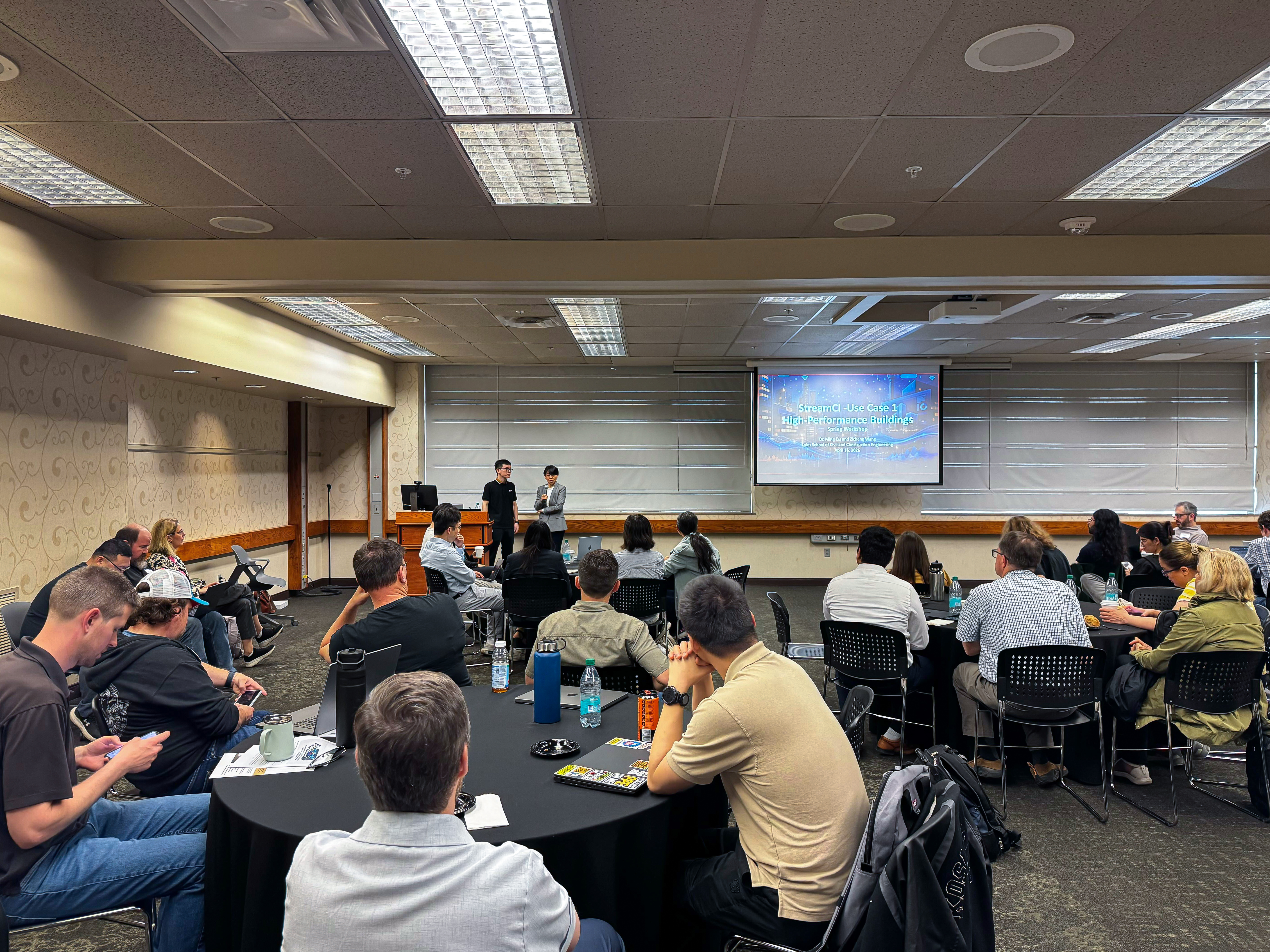 Faculty members showcasing StreamCI use case to room full of attendees