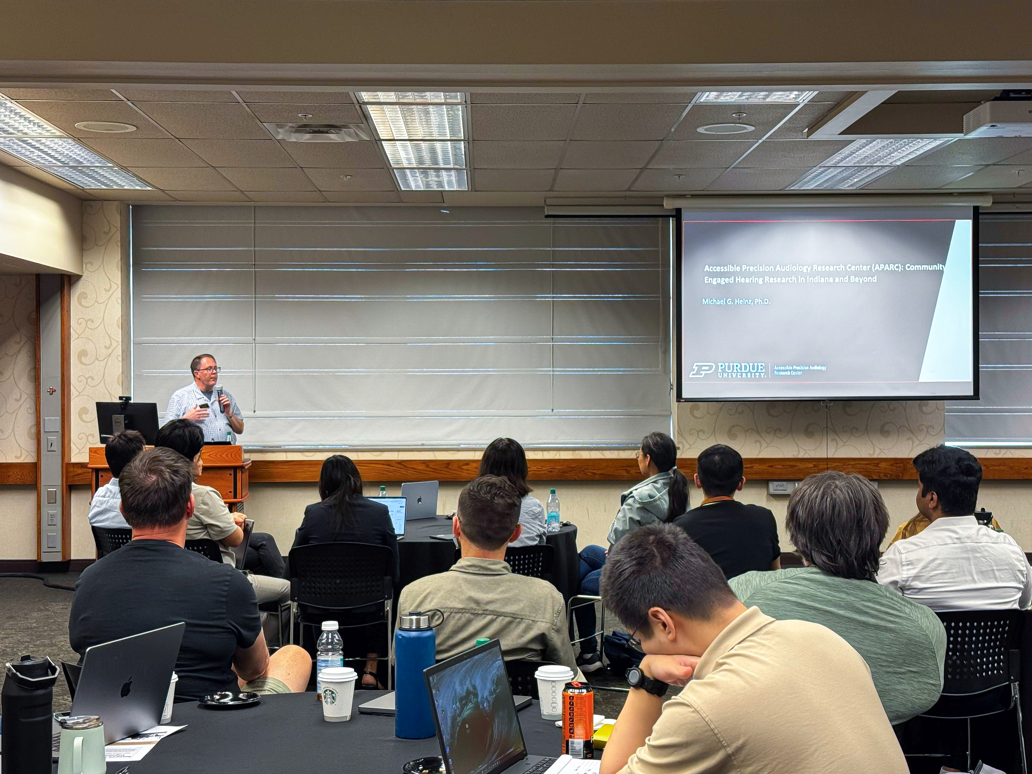 Faculty members showcasing StreamCI use case to room full of attendees