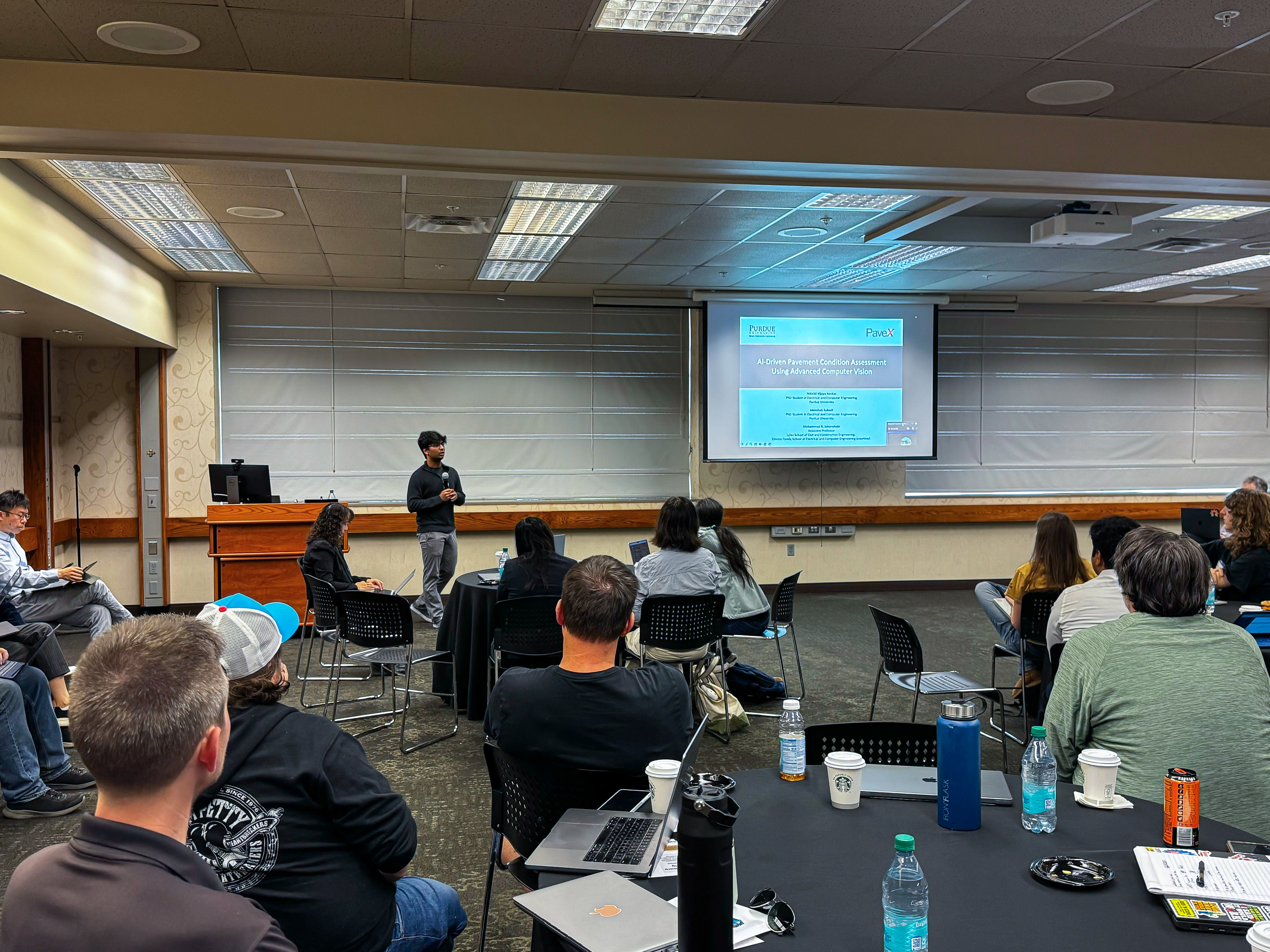 Faculty members showcasing StreamCI use case to room full of attendees