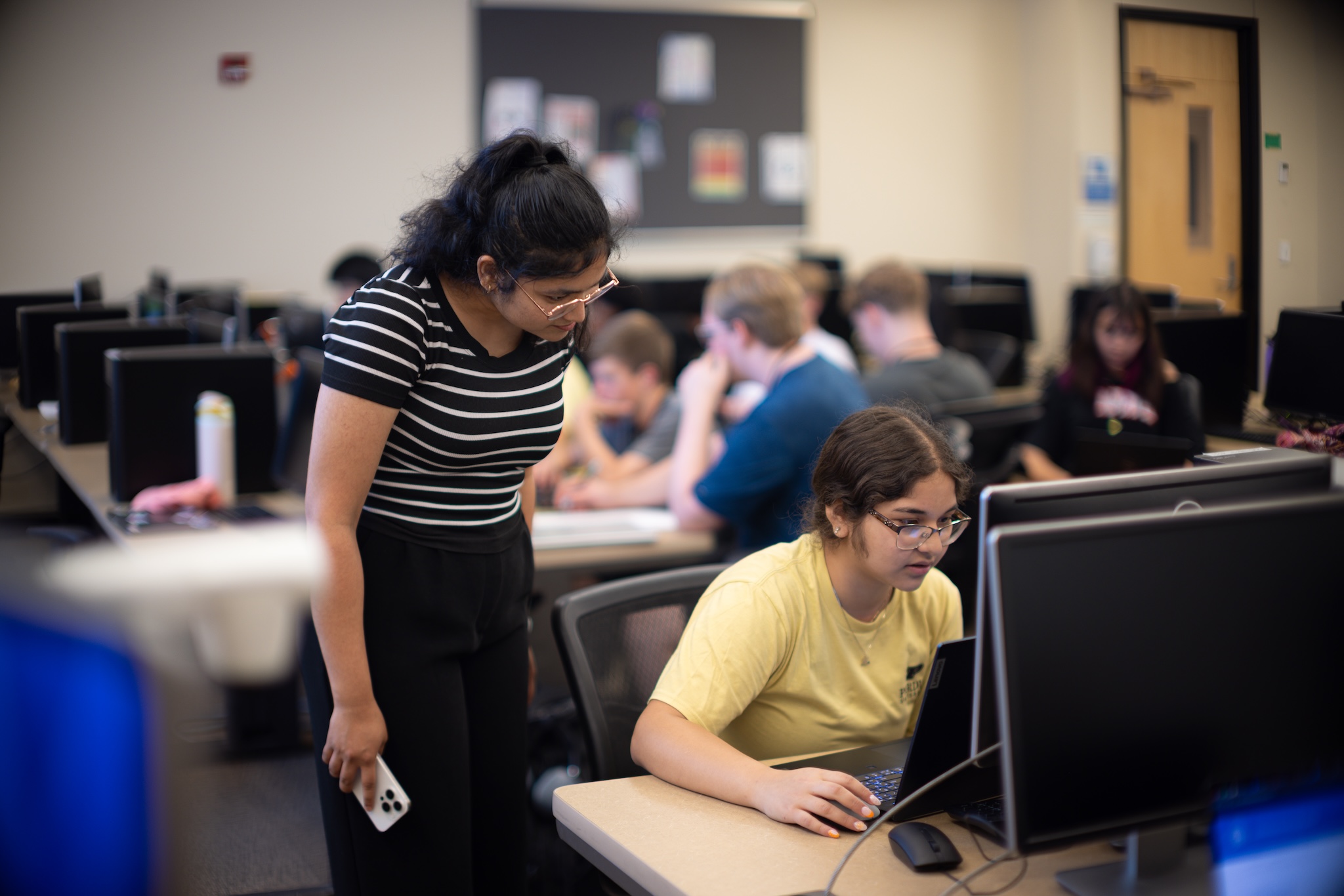 Madiha Fathima assisting camper during CyberSafe Heroes camp