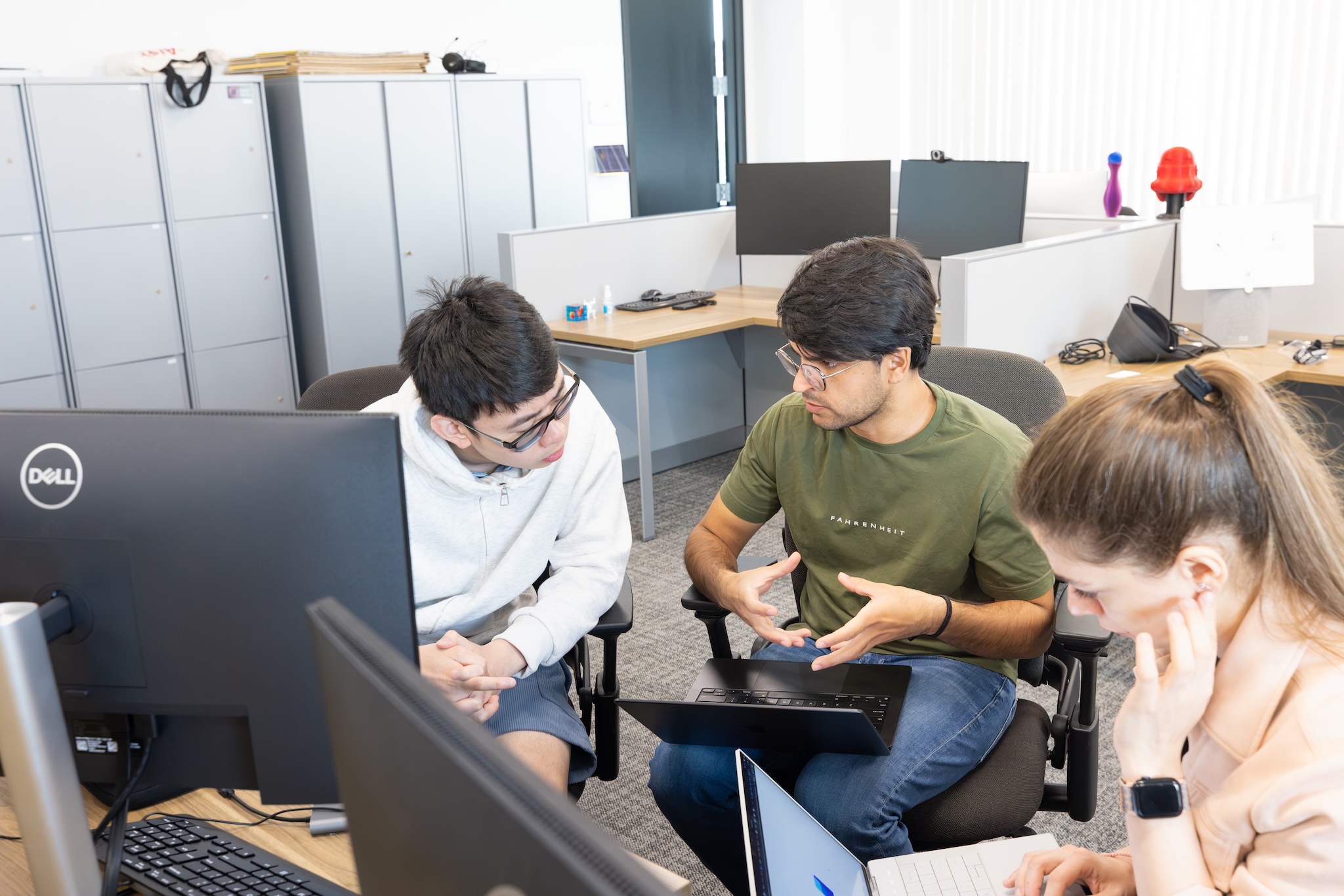 Two mentors working with student Howie Lin