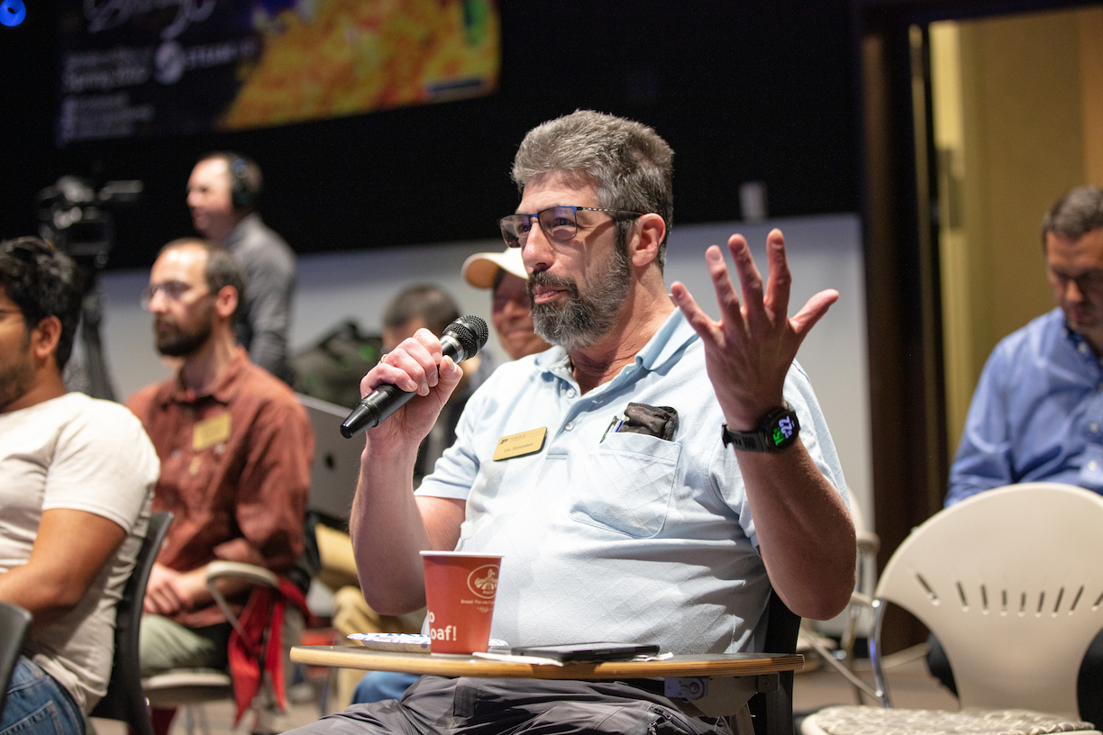 Lev asking questions at a symposium