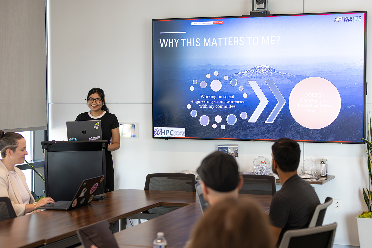 Madiha Fathima smiling while presenting at WHPC event